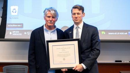 Lee Roberts holding Jefferson Award certificate next to Greg Forest.